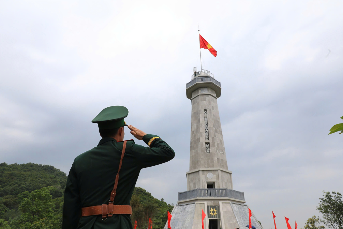 The sentry is performing the flag raising ceremony at A Pa Chai.